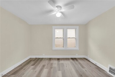 Spare room with ceiling fan and light hardwood / wood-style floors
