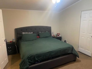 Bedroom featuring carpet and crown molding