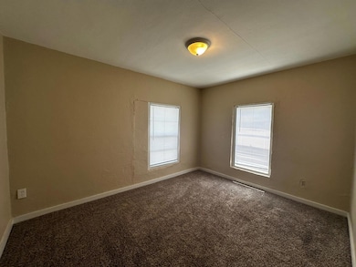 Unfurnished room featuring carpet flooring and ba