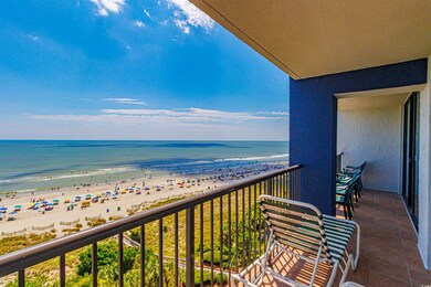 Balcony featuring a view of the beach and a water 