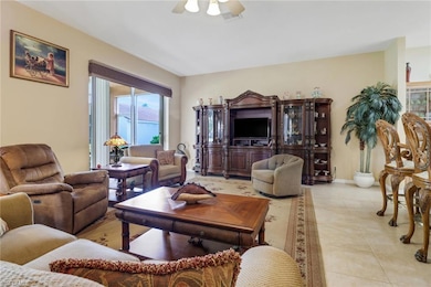 Tiled living room featuring ceiling fan and plenty