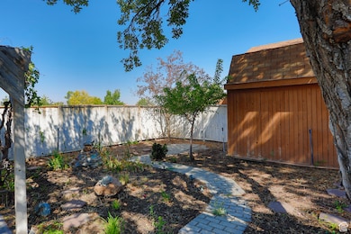 Fenced backyard with a storage unit