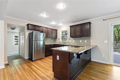 Kitchen featuring a peninsula, freestanding refrig