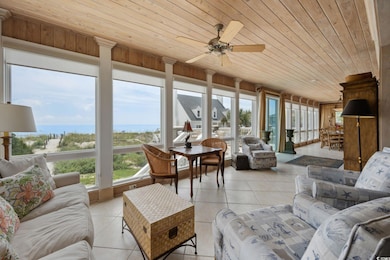 Sunroom / solarium with wood ceiling and ceiling f
