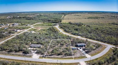 Aerial overview of property's location with a heavily wooded area and property boundaries highlighted