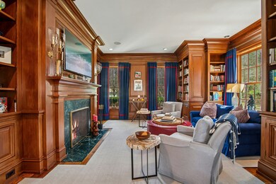 The warm and inviting den with fireplace is adjace