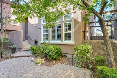 Welcome home! A charming walkway lined with greenery leads to your private front entry, perfect for a warm welcome every time.