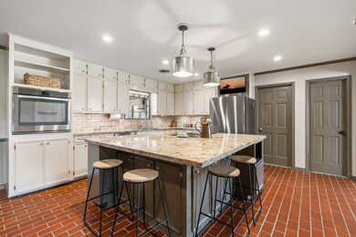 Another view of kitchen storage, appliances, and i