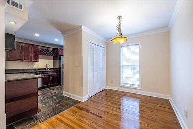 Dining area with open way to kitchen and wood fini