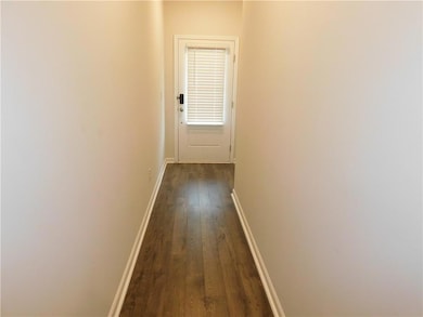Hallway with dark wood finished floors