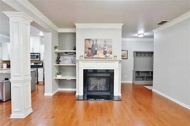 Unfurnished living room with a glass covered firep