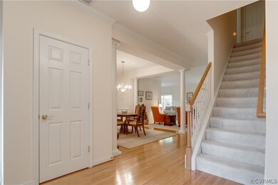 Lovely foyer greets you with hardwood floors & coa