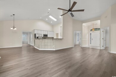 Unfurnished living room featuring ceiling fan with