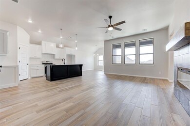 Unfurnished living room featuring ceiling fan with