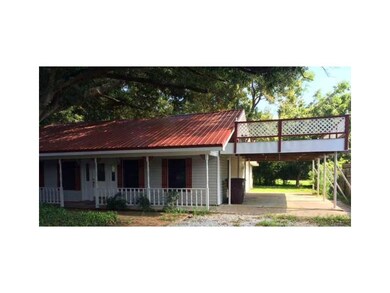 Exterior Front. Front, covered carport, and deck