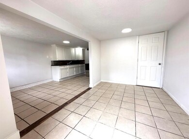 Bright and neutral living space with tile flooring
