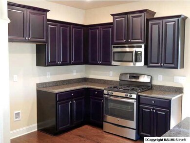 Beautiful kitchen featuring raised panel cabinets, recessed lighting, pendant lighting, under cabinet lighting, gas range ....