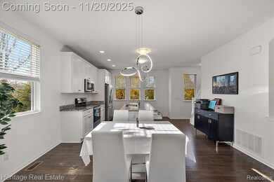 Dining area with dark wood-type flooring and recessed lighting