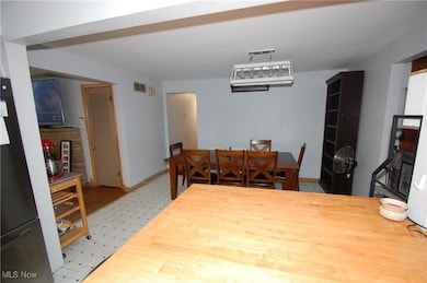 Dining area with light flooring and baseboards