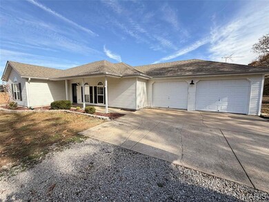 View of front facade with driveway, a garage, a shingled roof, and covered porch
