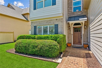 Doorway to property featuring brick siding