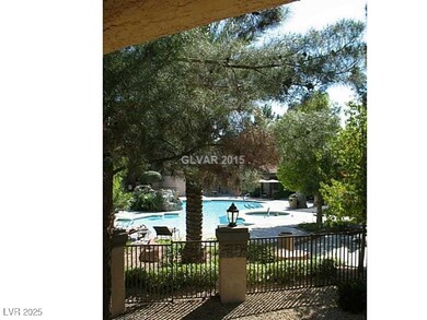 Community pool with a patio area and fence
