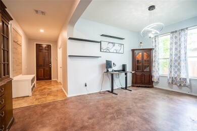 Office area featuring a chandelier and baseboards