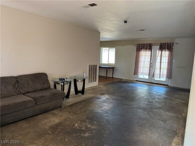 Living room featuring french doors, visible vents,