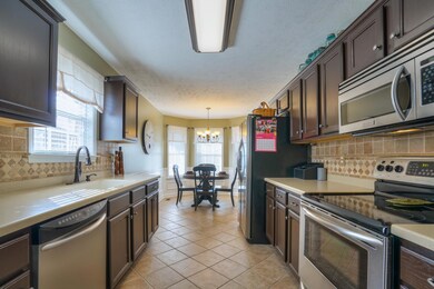 Custom Kitchen with Travertine Tile Backsplash