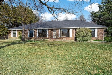 Classic ranch style home has a massive front lawn 
