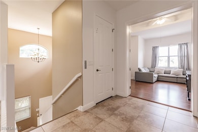 Front door and garage entry with stairs or private