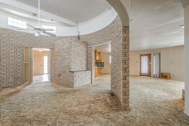 Carpeted spare room with a high ceiling and a ceiling fan