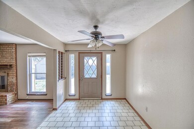 Entrance foyer with a fireplace, hardwood / wood-s