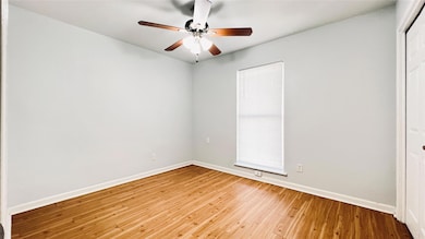Unfurnished room with wood-type flooring and a ce