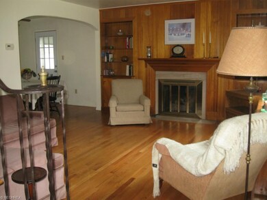 Light-drenched living room featuring hardwood floo