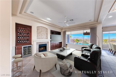 Living room featuring visible vents, a raised ceil