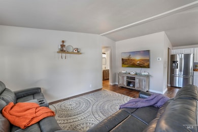 Living area featuring wood finished floors and vaulted ceiling