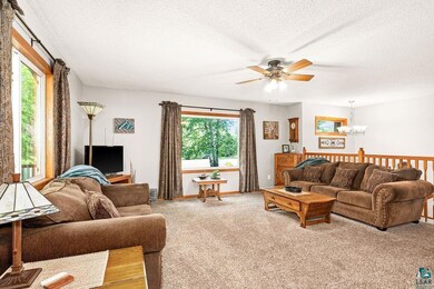 Living room with a textured ceiling, carpet floors