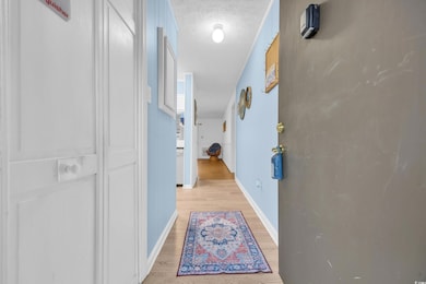 Hall with a textured ceiling, light wood finished 