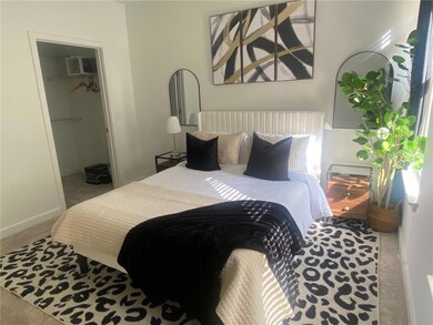 Bedroom with carpet, a closet, and a spacious clos