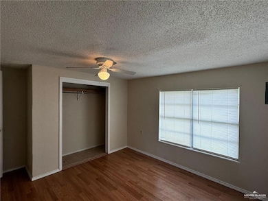 Unfurnished bedroom featuring hardwood / wood-style floors, ceiling fan, a textured ceiling, and a closet