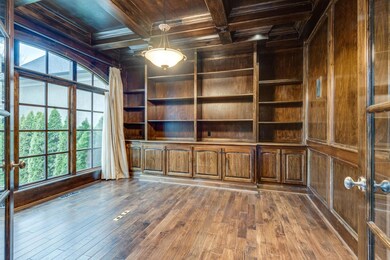 Another view of the library showing coffered ceilings and built-ins