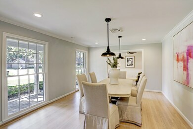 Dining room has hardwood floors, large windows and