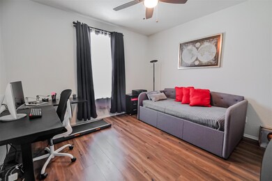Office with wood-type flooring and ceiling fan