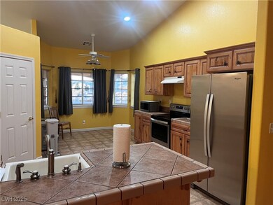 Kitchen featuring tile countertops, appliances wit