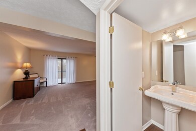 View from entry hall into the living room and powder room.