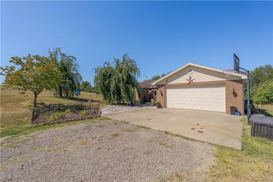 View of front of property with driveway and brick siding