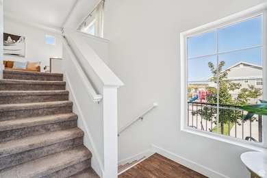 Stairs featuring wood finished floors and baseboards