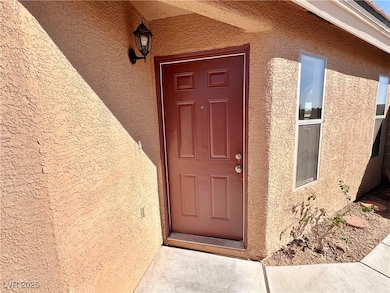 Doorway to property with stucco siding
