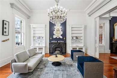 Double parlor living room showcases a beautiful ch